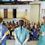 The Trinity students giving an oral health presentation to local school children