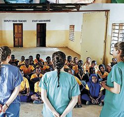 The Trinity students giving an oral health presentation to local school children