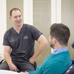 Dentist chatting to patient