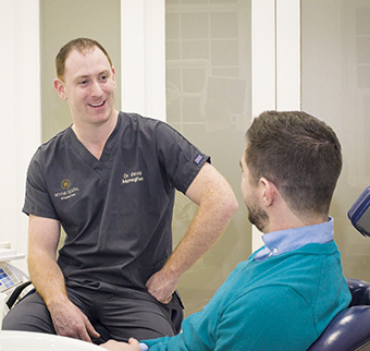 Dentist chatting to patient