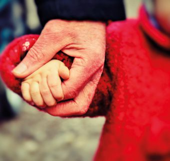 Adult and child holding hands