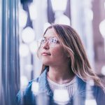 Woman looking thoughtful in blurred lighting