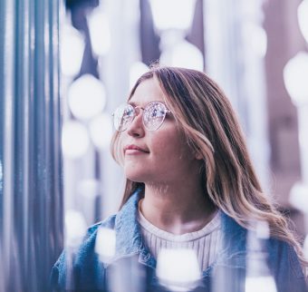 Woman looking thoughtful in blurred lighting