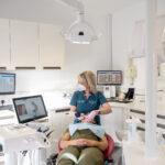 A dentist performs a check up on a patient in a state-of-the-art surgery