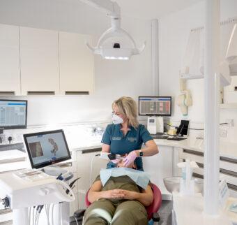 A dentist performs a check up on a patient in a state-of-the-art surgery