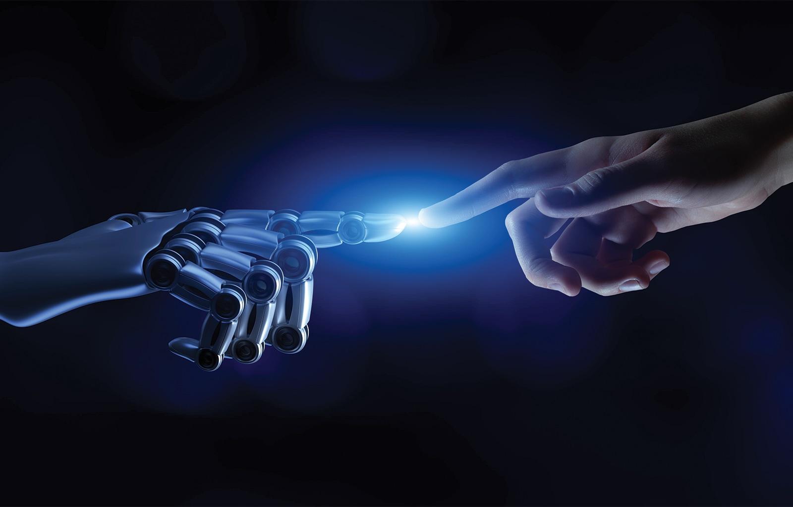 A robot and human hand touch at the index finger.
